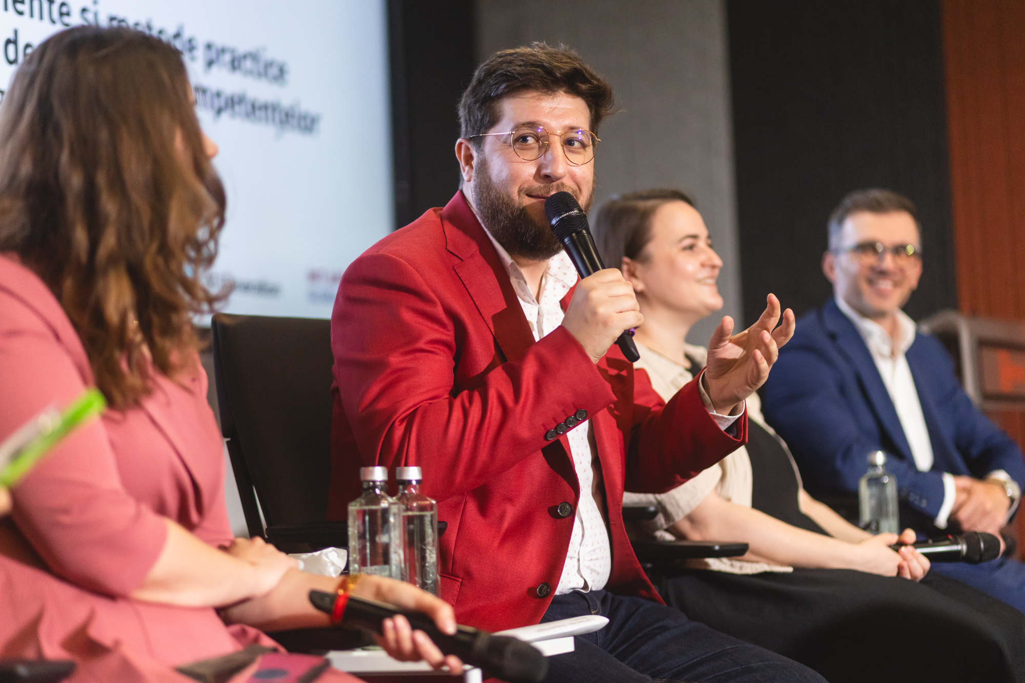 Dragoș Apostu speaking on a conference panel.